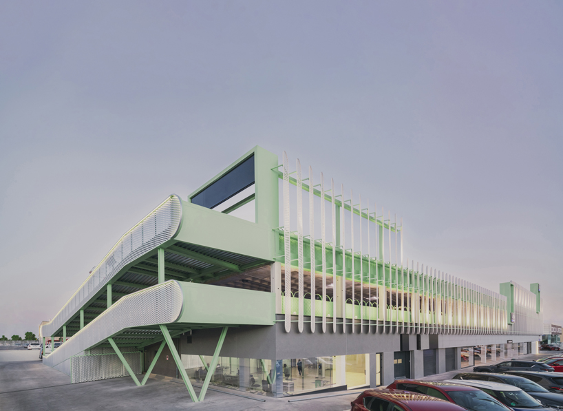 OOIIO wraps reused madrid auto center in permeable skin of vertical metal slats - 1