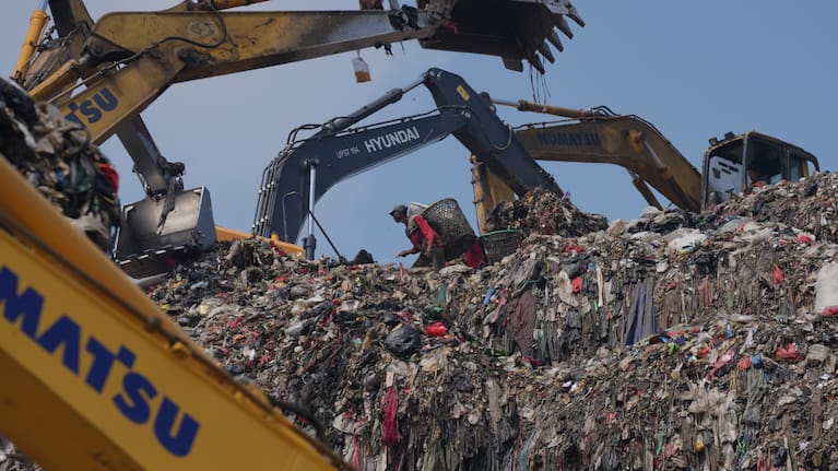 Waste pickers look for recyclable items in a pile of garbage at the Bantargebang landfill.