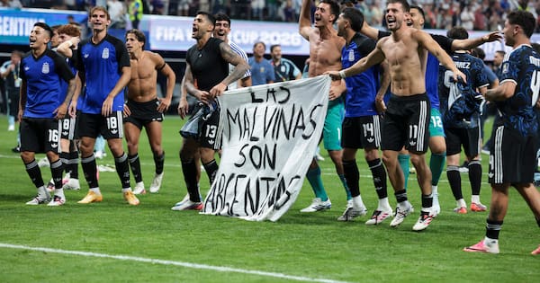 Argentina players hold Falklands banner after beating England