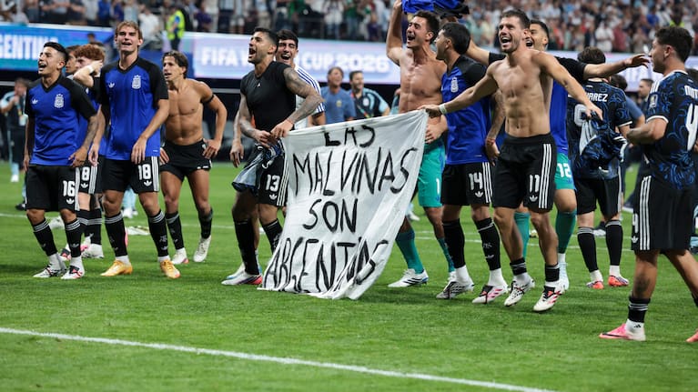 Argentina players hold up a banner referencing the Falklands war after defeating England in the World Cup semi final. 