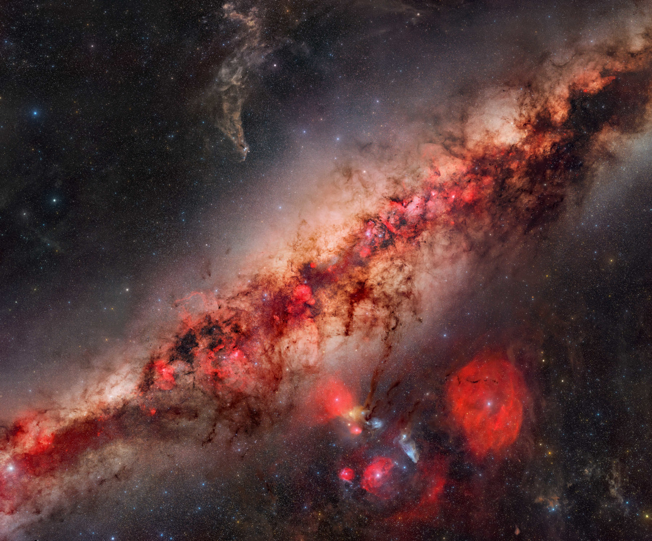 Stars & Nebulae. "A Deep Look Into the Milky Way's Core" © Jakob Sahner (Germany). This Milky Way mosaic was captured using two cameras – one for RGB colour and one for H-alpha – to record as much detail and structure as possible. The project nearly fell apart when unexpected Newton’s rings (an optical phenomenon that can occur when working with filters) appeared in many of the panels after stacking. Jakob Sahner considered abandoning the entire dataset, but eventually found a way to correct most of it and preserve the image. In the end, it became a roughly 750-megapixel mosaic. Taken with a Sony Alpha 7 III and Nikon Z 6 cameras, Samyang 135 mm f/2 lens, Sky-Watcher Star Adventurer GTi mount, 135 mm f/2, ISO 1600, 1,950 x 90-second H-alpha exposures, 2,182 x 90-second RGB exposures. Location: Koireb, Windhoek Rural, Namibia, 19 May–1 June 2025