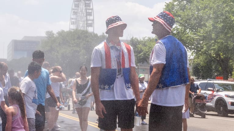 Attendees cool off in mist at the Great American State Fair on the National Mall in Washington.