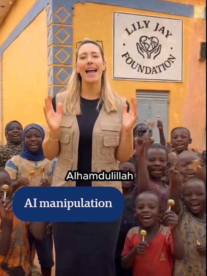 An orange and blue building. In the foreground there are African children waving their hands.