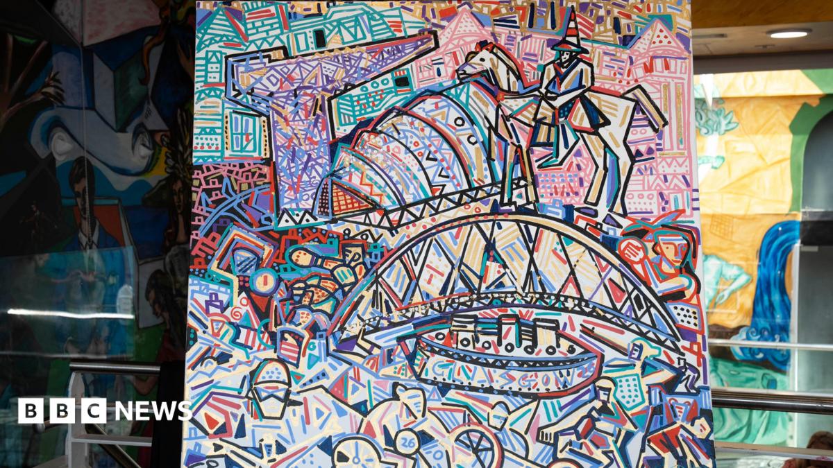 An abstract, expressionist painting of bright colours that show Glasgow's landmarks. There is a bridge, a crane and a statue painted amongst other abstract pictures. The painting is on an easel central to the photograph.