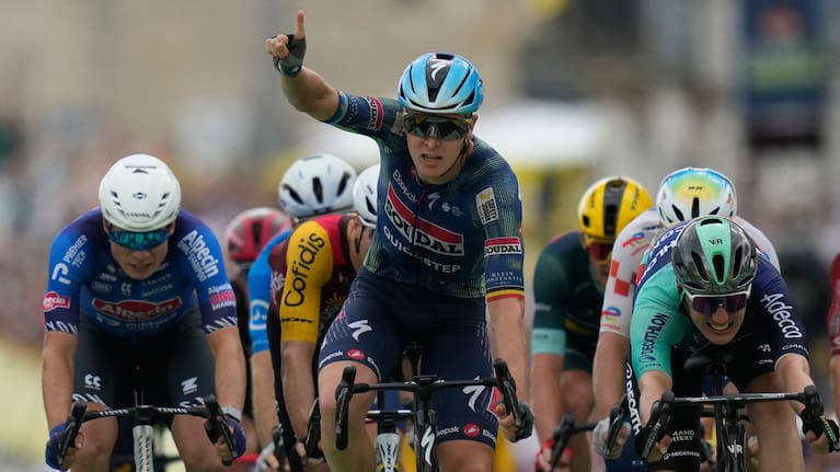 Belgium's Tim Merlier celebrates as he crosses the finish line to win the twelfth stage of the Tour de France cycling race.