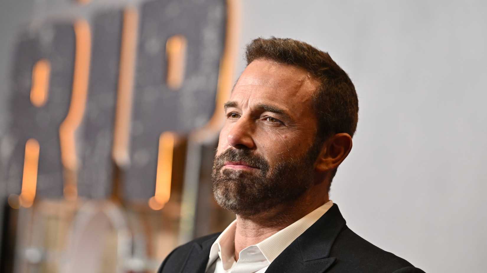 Ben Affleck smiles on the red carpet.