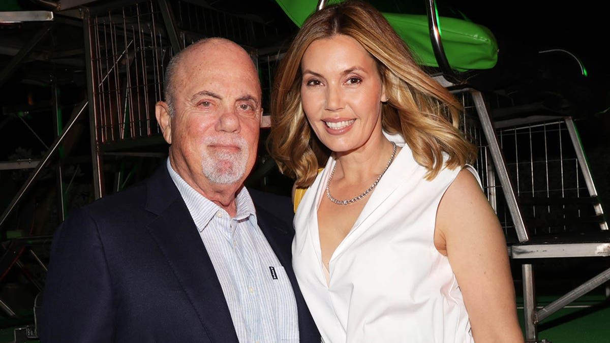 Billy Joel and Alexis Joel smiling together at an event in Palm Beach, Florida