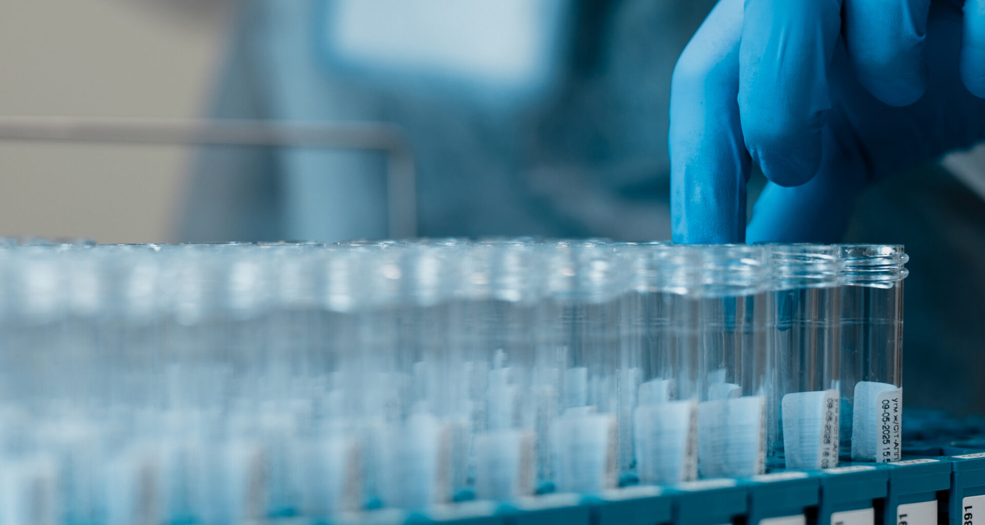 Lab technician pulls test tubes of specimens.