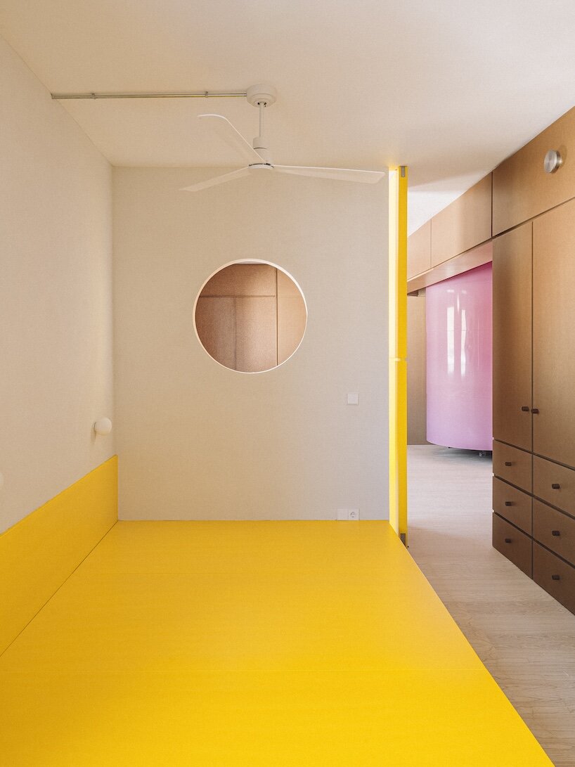 burr wraps madrid apartment in yellow storage walls with a suspended pink spiral staircase - 3