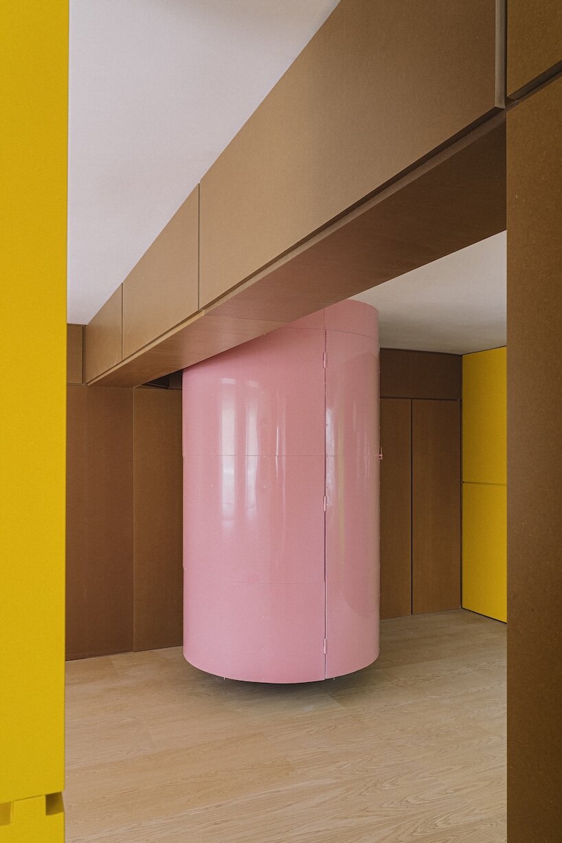 burr wraps madrid apartment in yellow storage walls with a suspended pink spiral staircase - 4