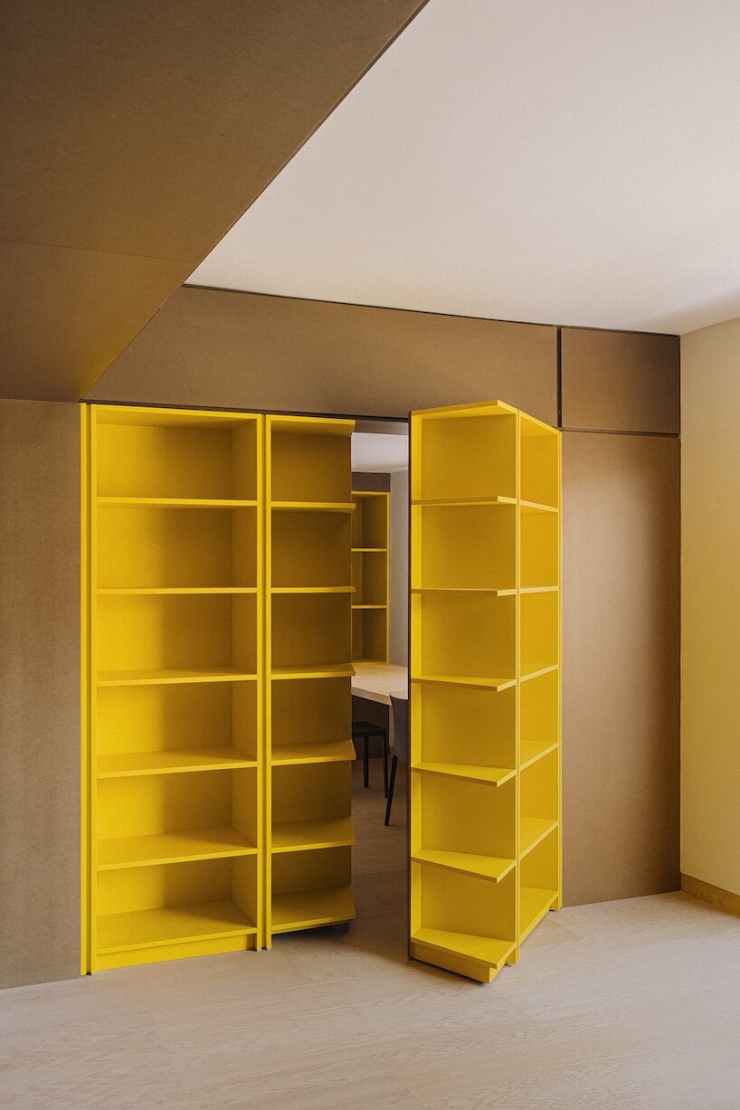 burr wraps madrid apartment in yellow storage walls with a suspended pink spiral staircase - 2