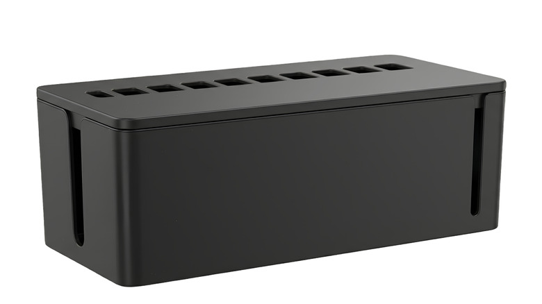 A black cable management box with openings in the lid and side routing slots.