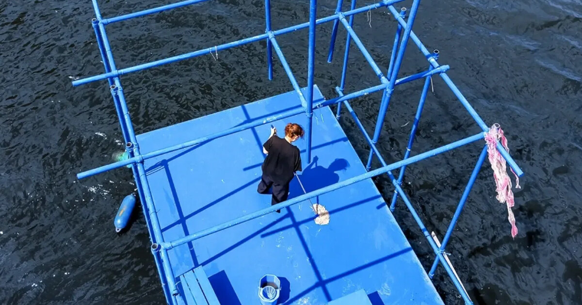 an endless act of cleaning unfolds on a floating platform in berlin