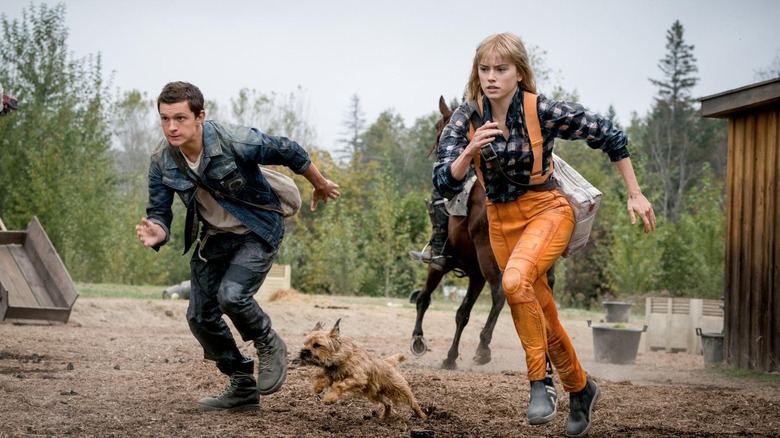 Tom Holland as Todd and Daisy Ridley as Viola running away in Chaos Walking