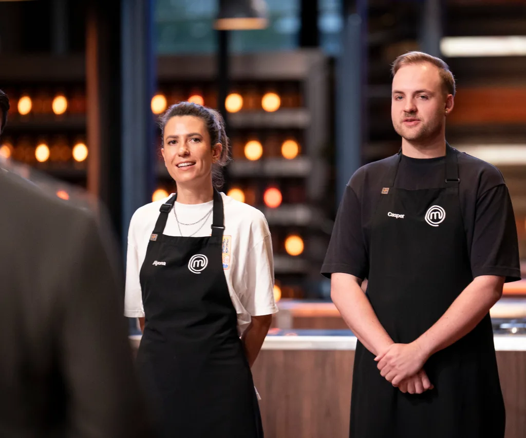 Alyona Iljuhhina standing beside Casper in the MasterChef Australia kitchen wearing black aprons.