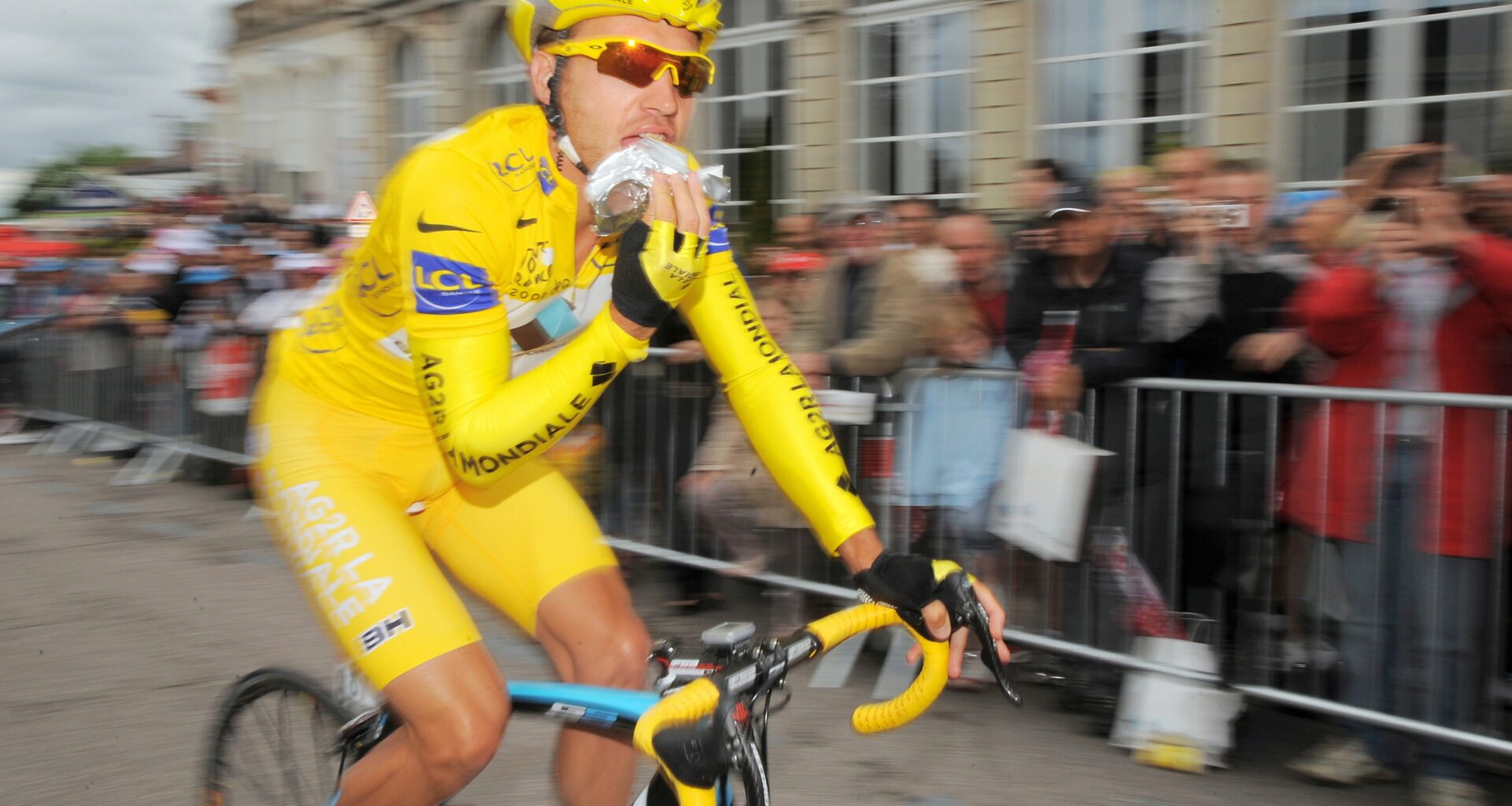A bicycle racer eats during competition.