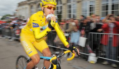 A bicycle racer eats during competition.