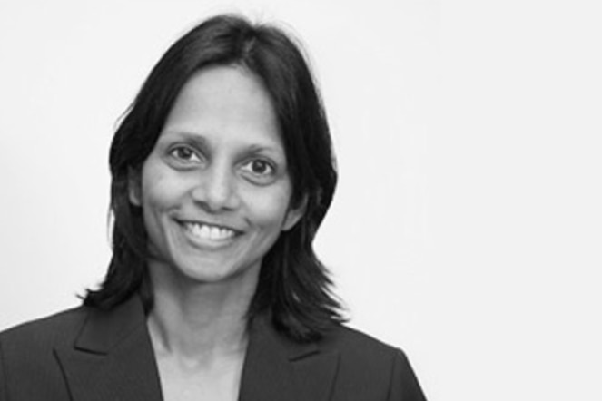 A smiling Indian woman in a posed portrait picture