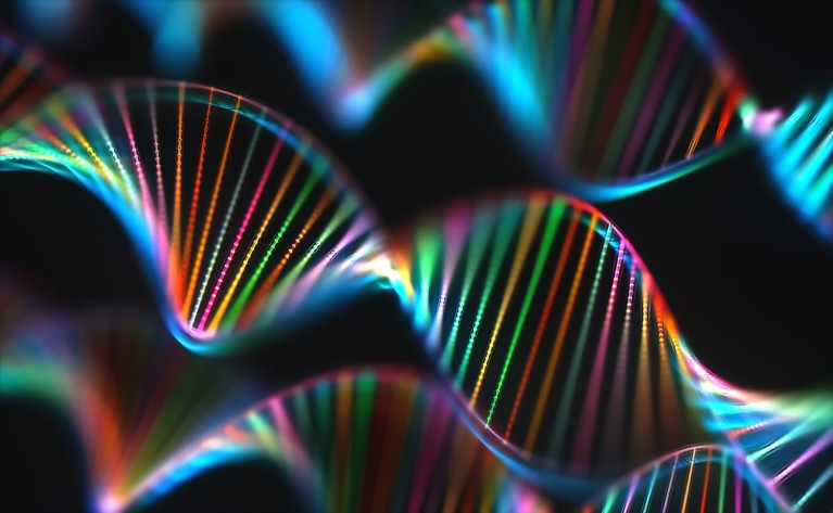 Colourful illustration of multiple DNA double helix strands glowing in vibrant rainbow colours against a black background