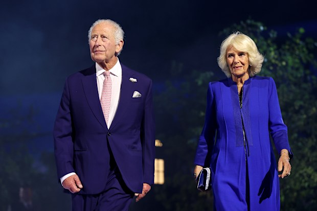 King Charles III and Queen Camilla walk on stage during the opening ceremony ahead of the Glasgow 2026 Commonwealth Games at The Hydro on July 23, 2026 in Glasgow, Scotland.