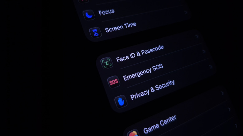 An iPhone held in a dark room with the screen showing the 