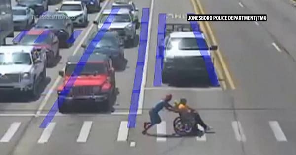 Driver dressed as Spider-Man leaps to the aid of man in a wheelchair