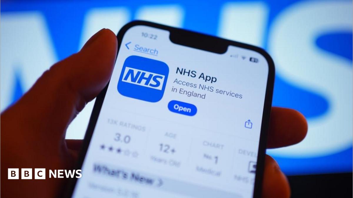 A hand holds a smartphone displaying the NHS app after it has been downloaded.
