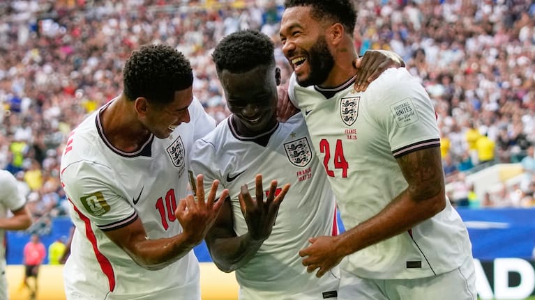 England's Bukayo Saka (7) is congratulated by Jude Bellingham (10) and Reece James (24) after scoring his side's 5th goal from the penalty spot during the World Cup