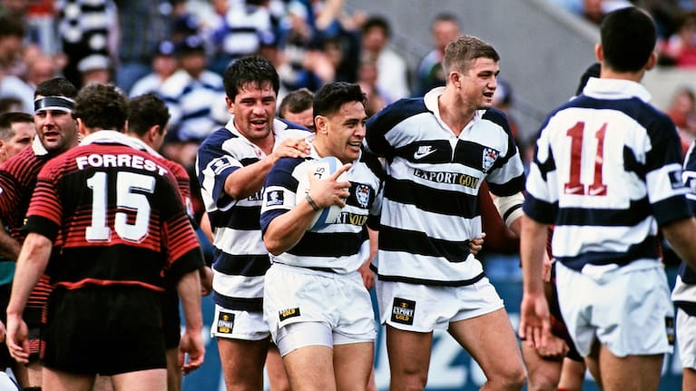 Eroni Clarke, with ball, celebrates a try for Auckland alongside teammate and fellow All Black Zinzan Brooke, left, in 1995.