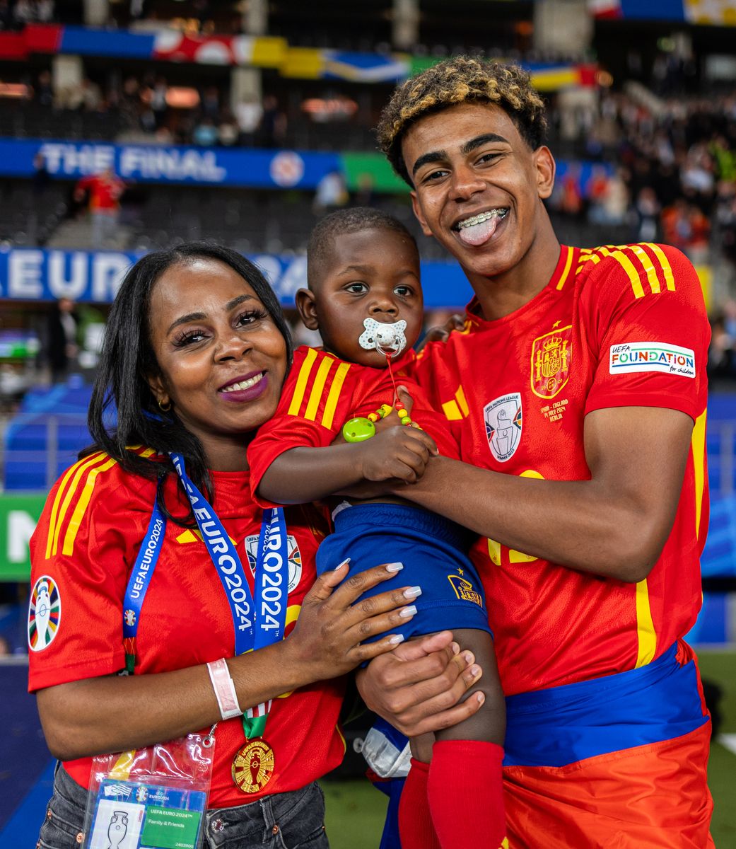 Lamine Yamal of Spain poses for a photograph with his Mother, Sheila Ebana, and his Brother as he celebrates victory after the UEFA EURO 2024 final