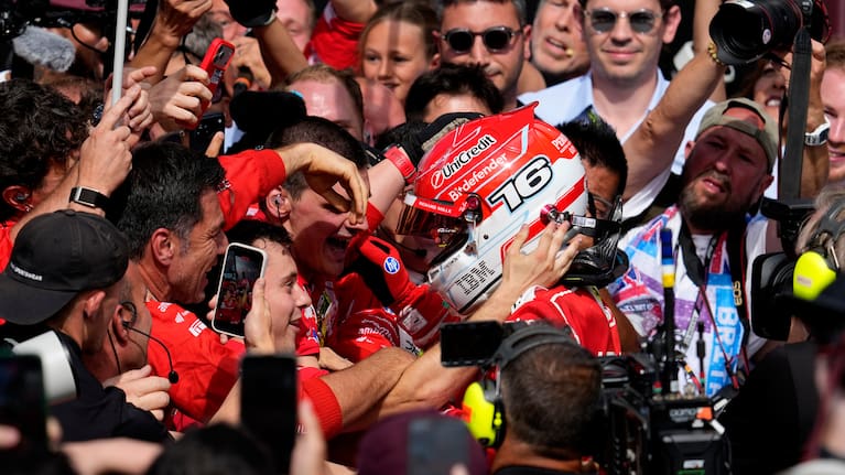 Ferrari driver Charles Leclerc of Monaco celebrates with his team after winning the British F1 Grand Prix, in Silverstone, England.