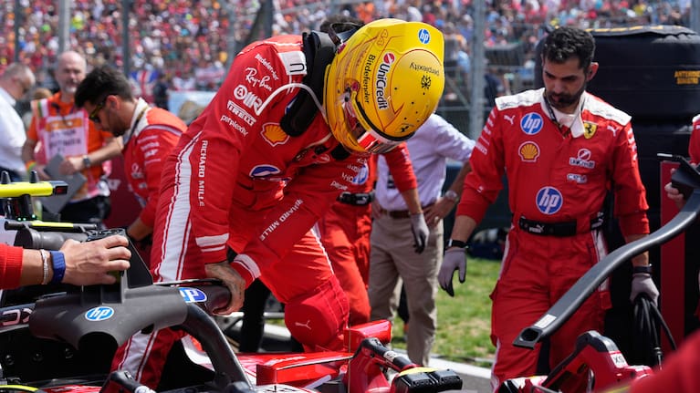 Ferrari driver Lewis Hamilton of Britain gets in his car ahead of the Formula One Hungarian Grand Prix auto race, at the Hungaroring racetrack in Mogyorod, near Budapest, Hungary.