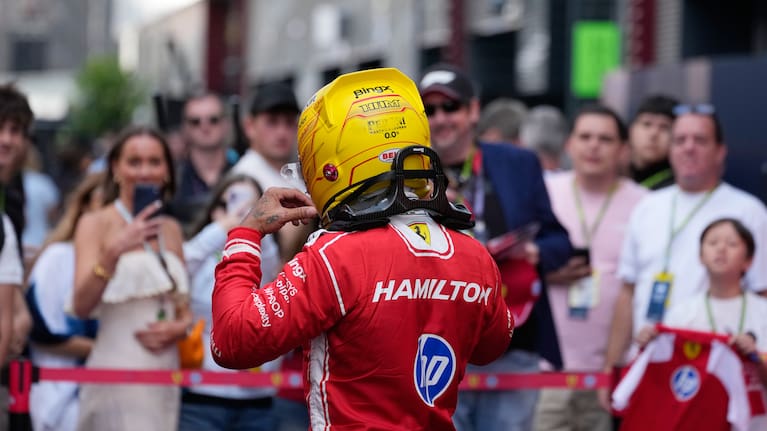 Ferrari driver Lewis Hamilton of Britain walks past supporters after the first free practice ahead of Sunday's Formula One Hungarian Grand Prix
