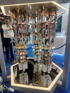 A machine made up of metal disks, rods and electronics, on display in an exhibition hall