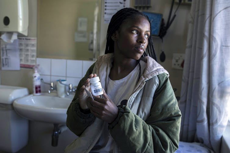 Woman holding a bottle of pills
