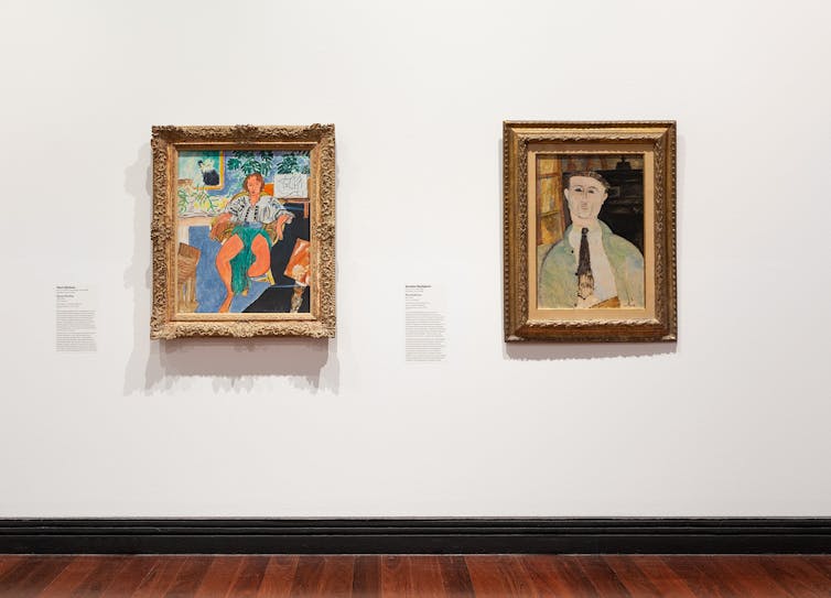 Two paintings in a gallery: portraits of a dancer, and a man.