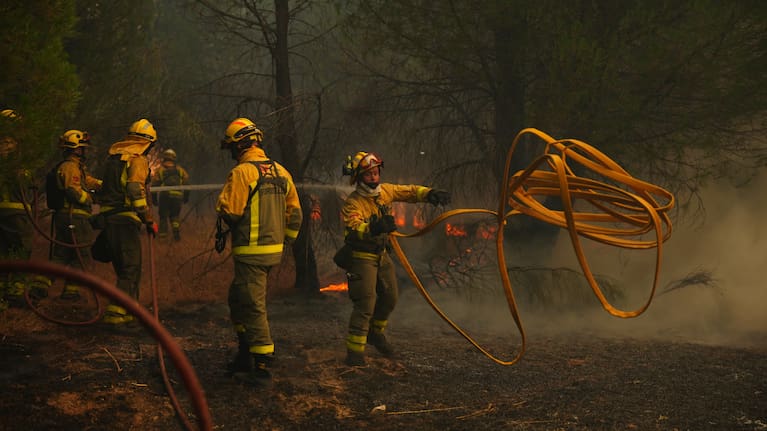Firefighters battle a wildfire in San Martin de Valdeiglesias, west of Madrid, Spain, Sunday, July 26, 2026.