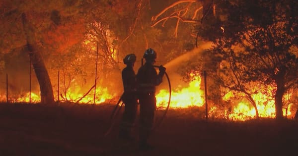 French president visits fire zone, vows: 'We will win this battle together'
