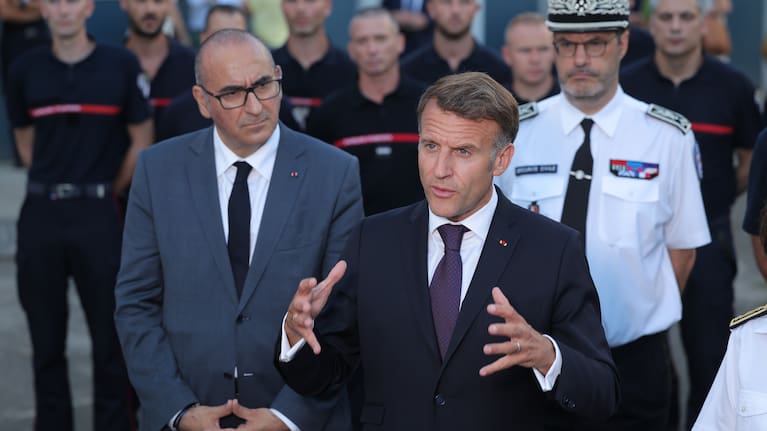 France's President Emmanuel Macron, center, speaks to the press next to Interior Minister Laurent Nunez, left, after a visit to the departmental fire and rescue operational centre in Bordeaux, France.