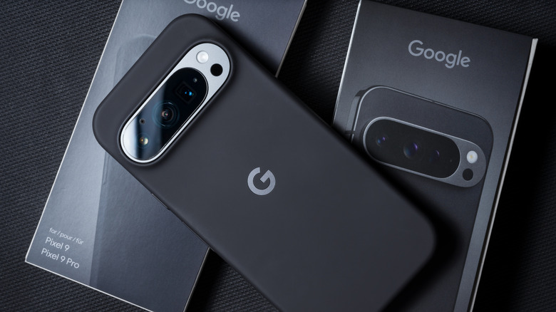 A Black Google Pixel 9 Pro on top of its box.