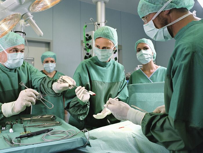 Surgeons performing an operation, highlighting the medical industry and uncomfortable truths in healthcare.