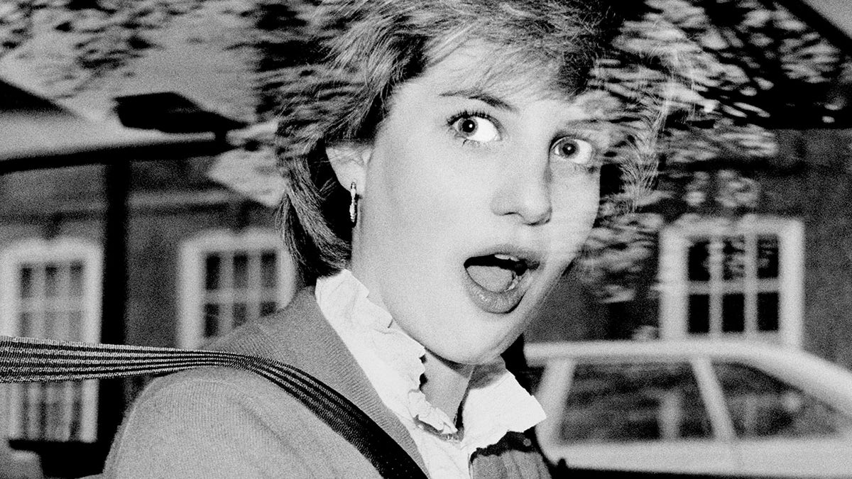 Lady Diana Spencer looking stunned inside her red Mini Metro car