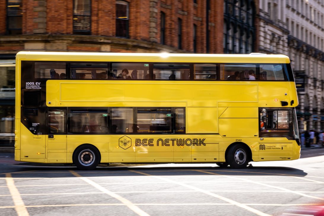 A Bee Network bus drives through Manchester city center on June 22, 2026.
