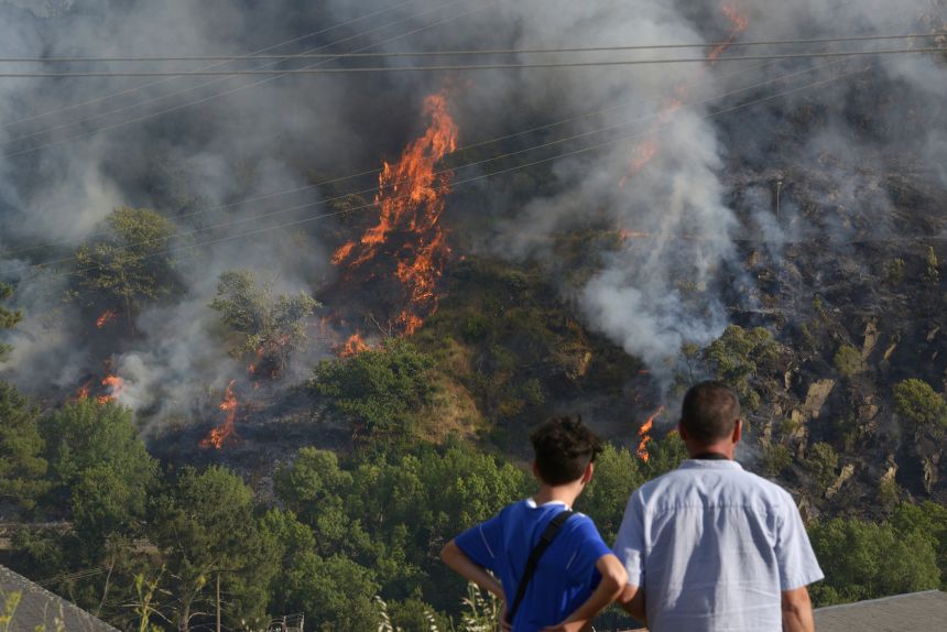 Onlookers watch the forest fire in Ribas de Sil, Galicia, Spain, on Sunday.