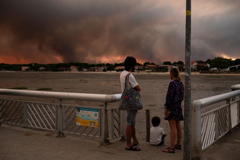 People watching the wildfire from the beach in the seaside town of Andernos-Les-Bains.