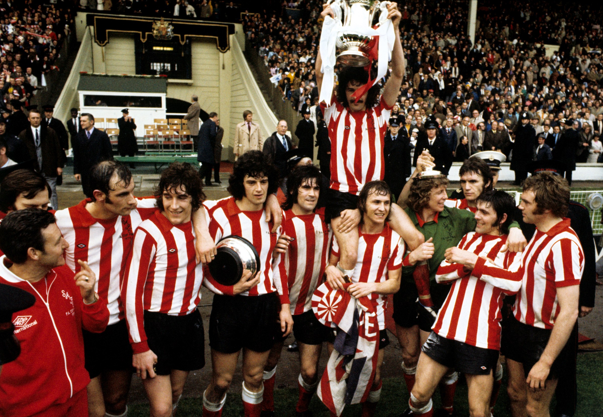 Sunderland’s captain Bobby Kerr held aloft by his teammates Billy Hughes and goalkeeper Jim Montgomery after their FA Cup Final victory against Leeds United at Wembley Stadium. Final Score: Leeds 0 Sunderland 1. The unlikely lads who wrote their names into FA Cup folklore with Sunderland in 1973 instantly became legends on Wearside. Keeper Jim Montgomery’s double save, Ian Porterfield’s goal and manager Bob Stokoe’s joyous sprint across the Wembley turf made them household names across Britain and helped to cement the reputation of the football’s oldest knockout competition throughout the world. (Photo by PA Images via Getty Images)
