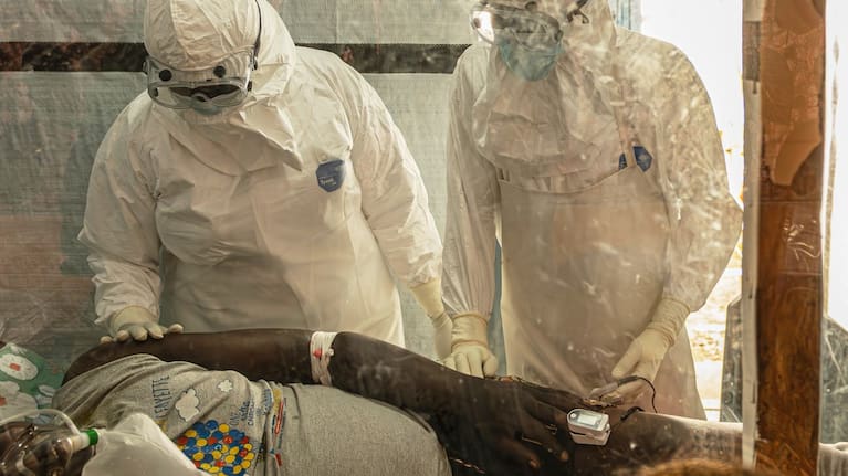 Health workers attend to an Ebola patient at the Rwampara treatment Centre in Ituri, Congo.