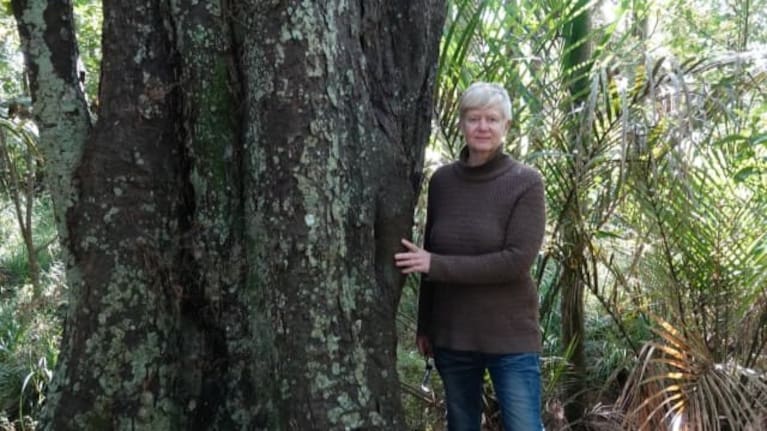 Heather Jean Bryham with one of the larger kahikatea trees on the family property.