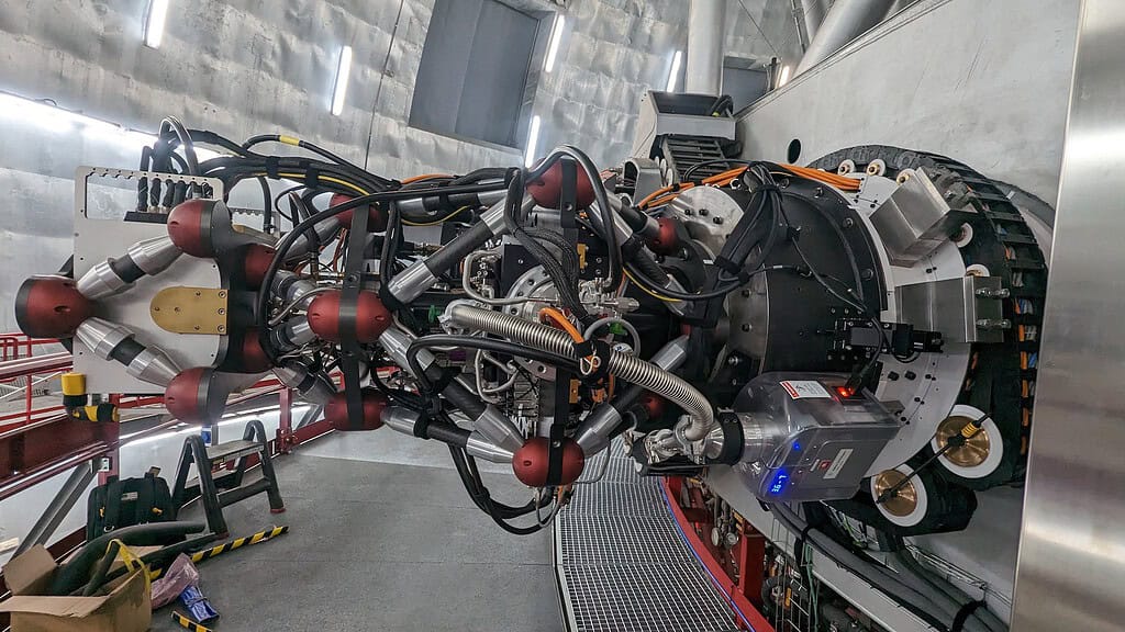 Complex particle accelerator with multiple components and wiring.