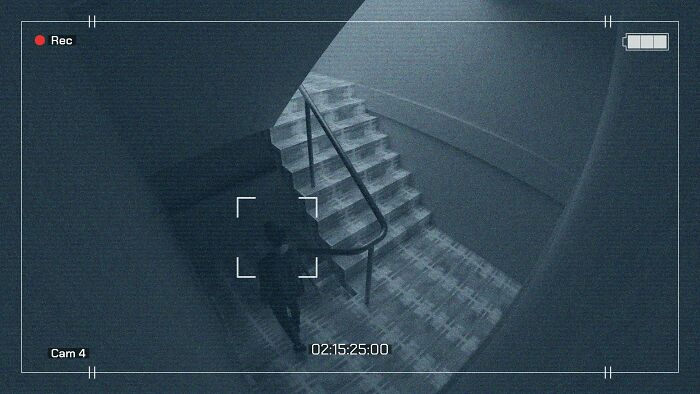 CCTV footage capturing a shadowy figure ascending a hospital staircase, evoking horror stories.